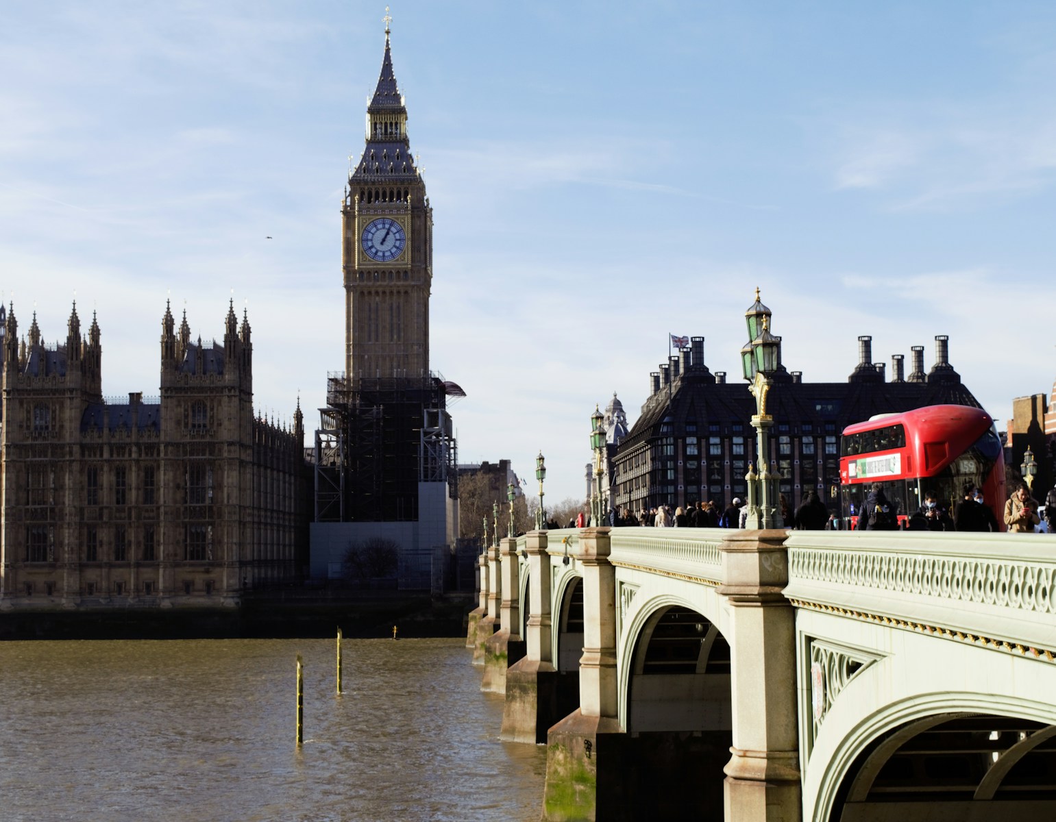 a bridge with a clock tower in the background