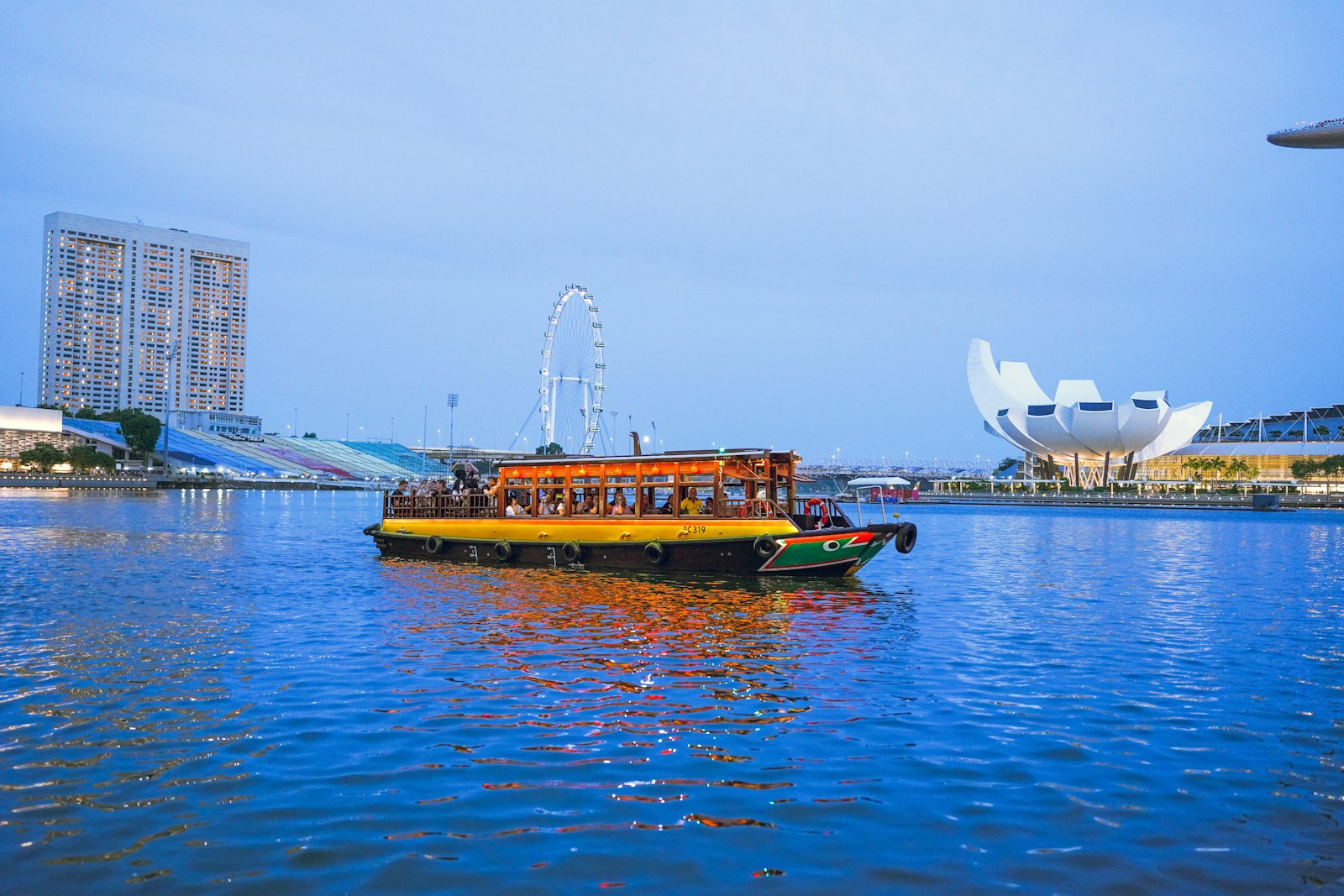 a yellow boat floating on top of a body of water