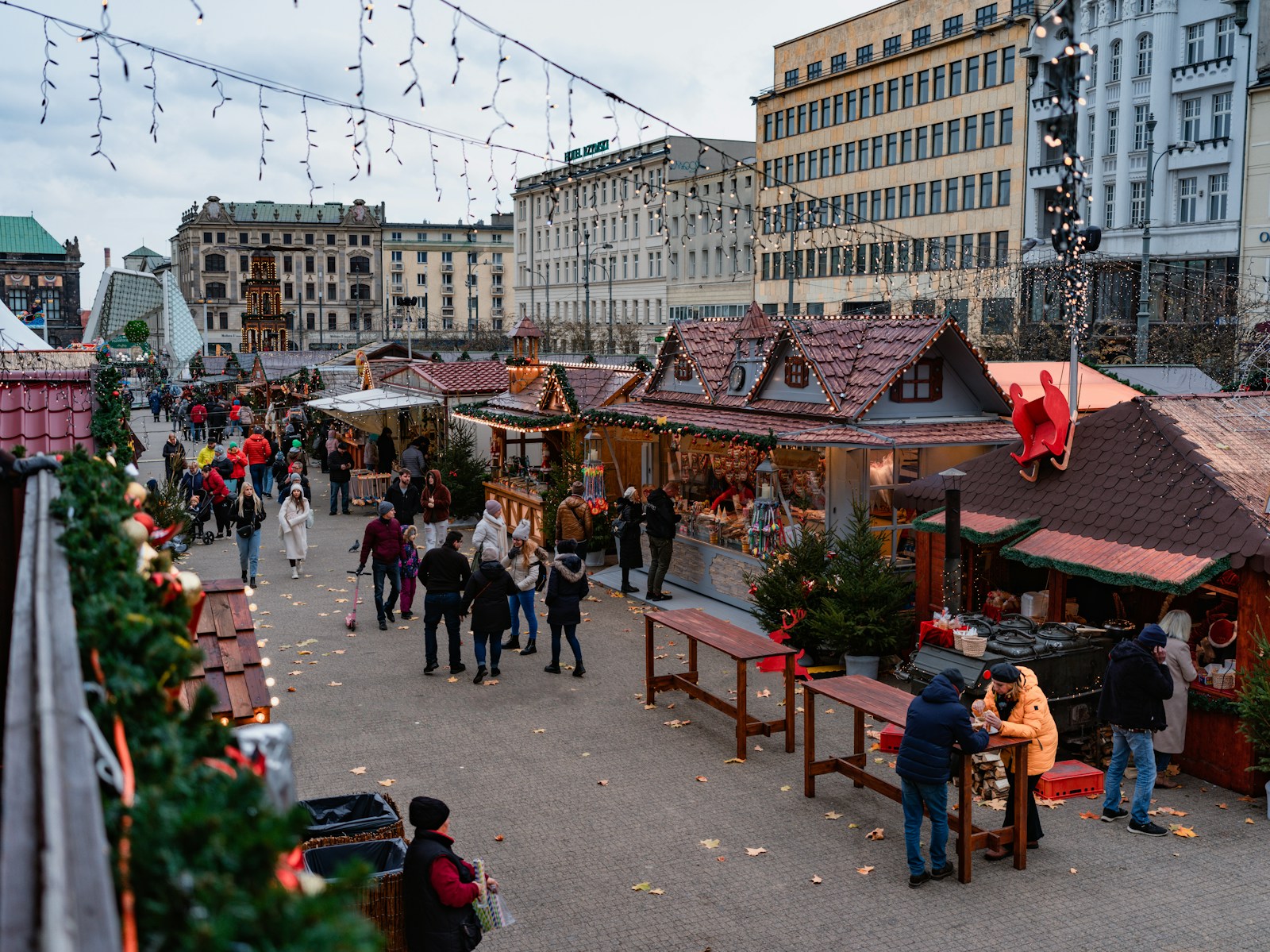 a group of people walking around a city