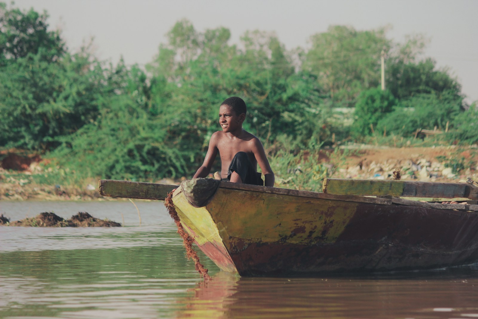 man in brown boat on river during daytime