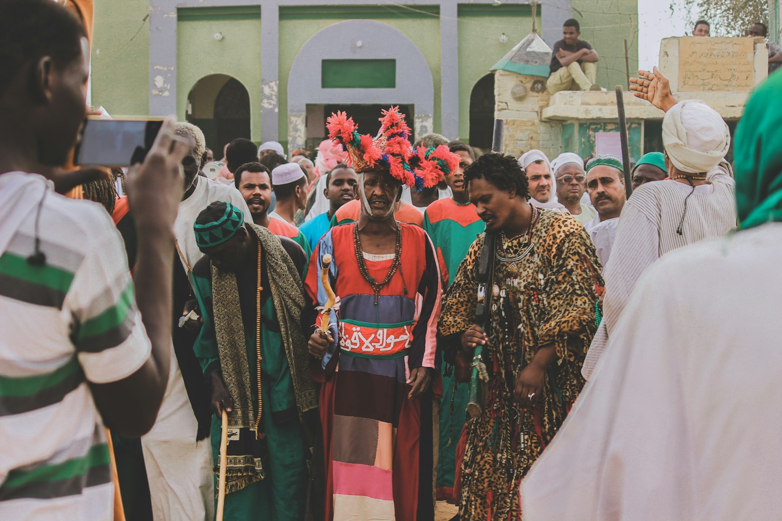 people in traditional dress standing on the street during daytime